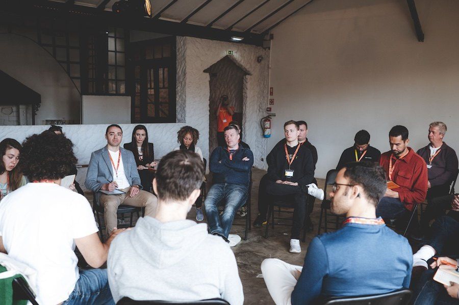 Sellers sitting in a circle during a collaborative Barcamp discussion